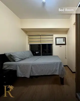 a bed in a bedroom with a bed room at Radiance Suite in Manila