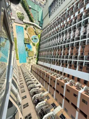 an overhead view of a building with cars parked in a parking lot at Radiance Suite in Manila