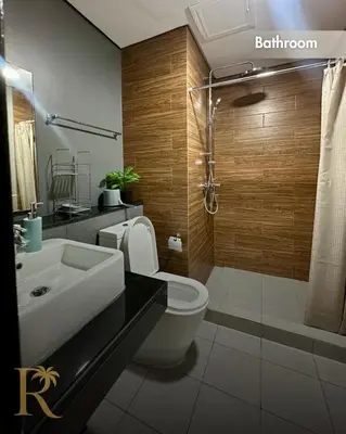 a bathroom with a sink and a toilet and a shower at Radiance Suite in Manila