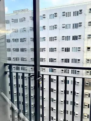 a view of two tall buildings from a window at Del Rosario Place Shore 2 Residence in Manila
