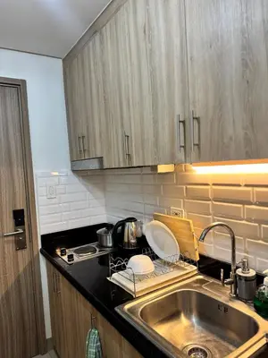 a kitchen with a sink and a counter top at Del Rosario Place Shore 2 Residence in Manila