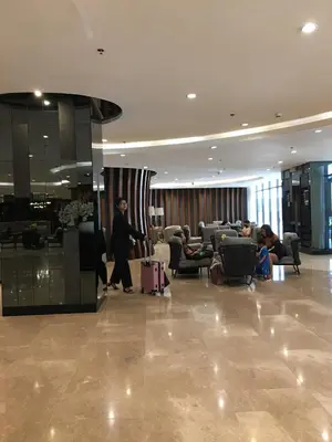 a person walking through a lobby with luggage at Del Rosario Place Shore 2 Residence in Manila