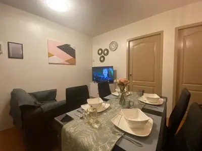 a living room with a table and a couch at Escapade Home in Manila