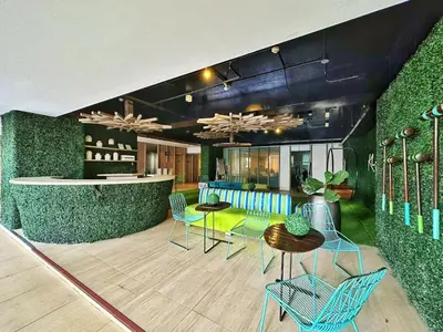 a lobby with chairs and a table and a bar at Private Unit at KL Tower Residences near Greenbelt Makati in Manila