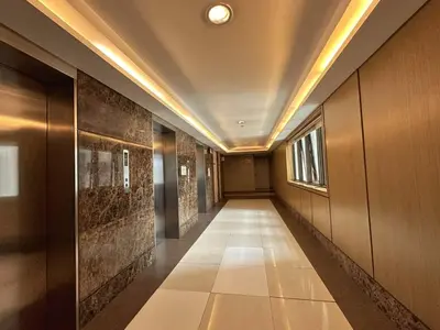 a hallway of a building with a long corridor at Private Unit at KL Tower Residences near Greenbelt Makati in Manila