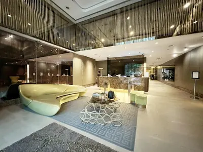 a large bathroom with a tub and a table at Private Unit at KL Tower Residences near Greenbelt Makati in Manila