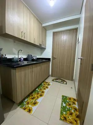 a kitchen with a sink and two mats on the floor at Shore 2 Residence Tower 2 in Manila