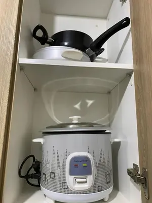 a slow cooker on a shelf in a kitchen at Shore 2 Residence Tower 2 in Manila