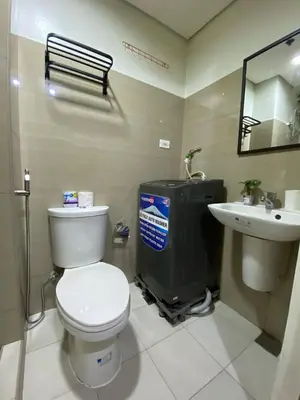 a bathroom with a toilet and a sink at Shore 2 Residence Tower 2 in Manila