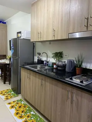 a kitchen with a sink and a refrigerator at Shore 2 Residence Tower 2 in Manila