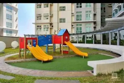 a playground with a slide in front of a building at Phebs 2bedroom with pool view in the heart of Makati in Manila