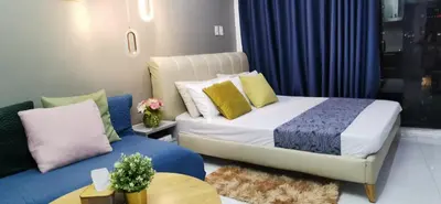 a small bedroom with a bed and a couch at Elite Pod Manila in Manila