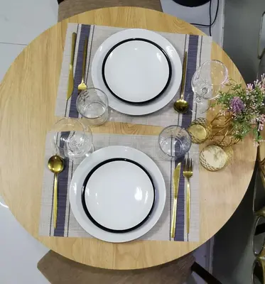 a table with white plates and forks and wine glasses at Elite Pod Manila in Manila