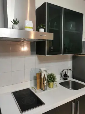 a kitchen with a sink and a counter top at Elite Pod Manila in Manila