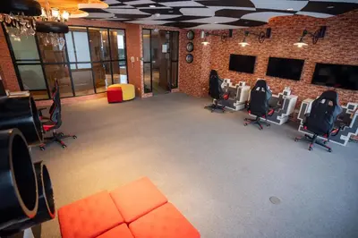 a large room with chairs and a brick wall at Elite Pod Manila in Manila