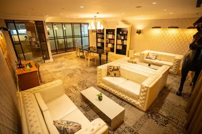 a large living room with couches and a table at Elite Pod Manila in Manila