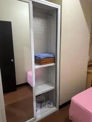 a closet with a mirror and some towels in it at Phebs 2bedroom Posh Condo in the heart of Makati in Manila