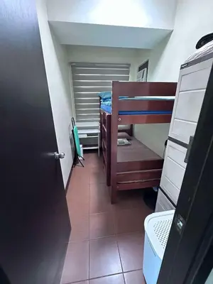 a small room with two bunk beds and a door at Phebs 2bedroom Posh Condo in the heart of Makati in Manila
