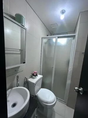 a bathroom with a shower and a toilet and a sink at Phebs 2bedroom Posh Condo in the heart of Makati in Manila