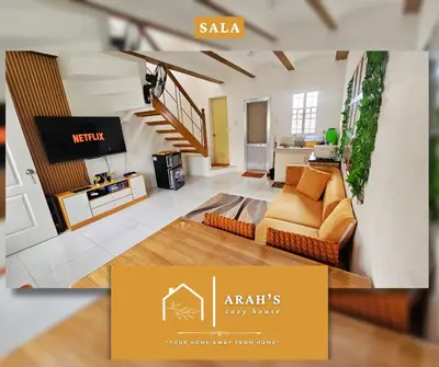 a living room with a couch and a tv at Arah Cozy House in Dasmariñas