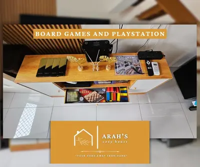 a stand for a board games and playstation with a table at Arah Cozy House in Dasmariñas