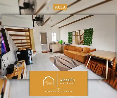 a living room with a couch and a table at Arah Cozy House in Dasmariñas