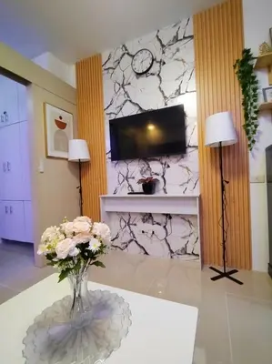 a living room with a vase of flowers on a table at Sea Residences - MOA in Manila