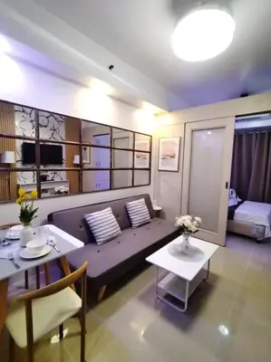 a living room with a couch and a table at Sea Residences - MOA in Manila