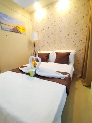 a hotel room with two swans on a bed at Sea Residences - MOA in Manila