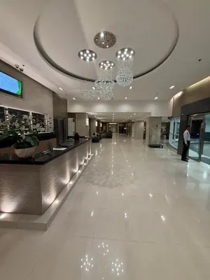 a lobby of a hotel with a chandelier at Sea Residences - MOA in Manila