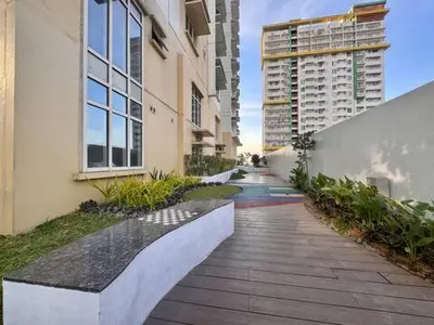 a walkway in front of a building with a bench at Urban Oasis Studio at Central District Makati in Manila