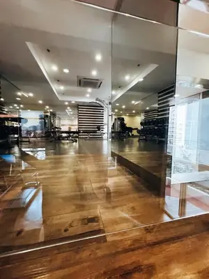 a large room with wooden floors and a glass wall at Urban Oasis Studio at Central District Makati in Manila