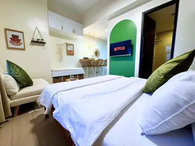 a bedroom with a bed and a sign that readsfaith at Urban Oasis Studio at Central District Makati in Manila