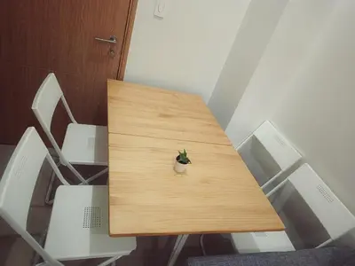 a wooden table with a small plant sitting on it at Paean's Pods at Bloom in Manila