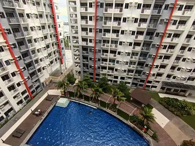 an overhead view of a swimming pool in front of tall buildings at Paean's Pods at Bloom in Manila