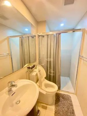 a bathroom with a toilet and a sink and a shower at Azure Cozy Hotel by CM staycation in Manila