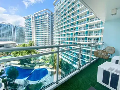 a balcony with a view of a large building at Azure Cozy Hotel by CM staycation in Manila
