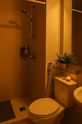 a bathroom with a toilet and a shower with a candle at Golden Hour Escape in Manila