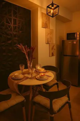 a kitchen with a table with chairs and a refrigerator at Golden Hour Escape in Manila
