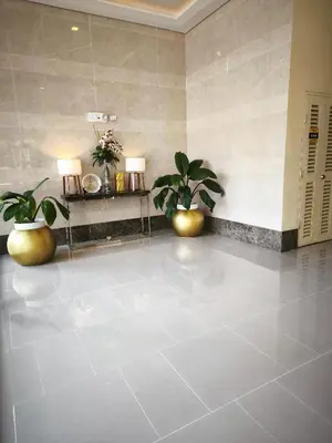 a lobby with two potted plants and two lights at Modern Studio Condo in Heart of Quezon City in Manila
