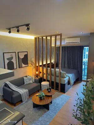 a living room with a bed and a couch at Sleek Designer Studio at Knightsbridge Residences in Manila