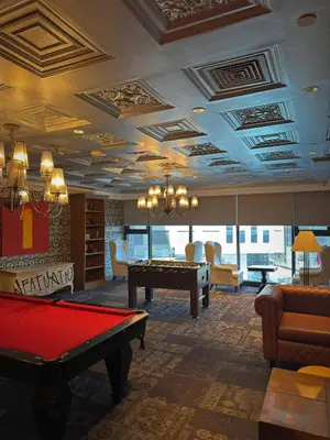 a hotel room with a pool table in a room at Sleek Designer Studio at Knightsbridge Residences in Manila