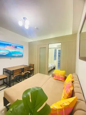 a living room with a couch and a table at LiCa Place in Manila