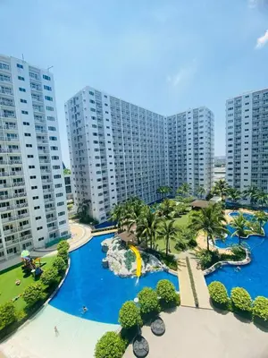 an aerial view of a water park with tall buildings at LiCa Place in Manila