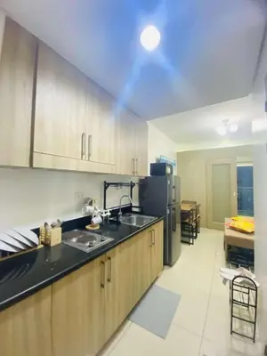 a kitchen with a sink and a refrigerator at LiCa Place in Manila