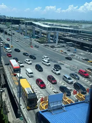 a highway filled with lots of cars in a parking lot at Airport View Walk to NAIA 3 in Manila
