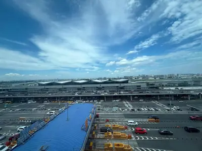 an airport with a parking lot with cars parked at Airport View Walk to NAIA 3 in Manila