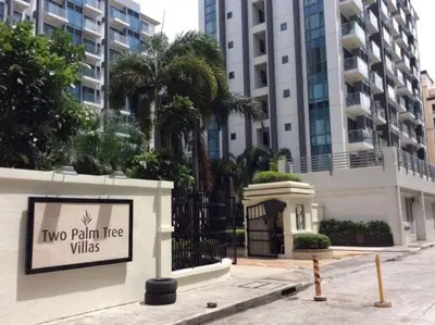 a sign for two palm tree villas in front of a building at Airport View Walk to NAIA 3 in Manila