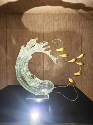 a glass sculpture of a wave with fish on a table at Cozy 1BR beside MOA with Wifi, Netflix, Pool & Washer in Manila