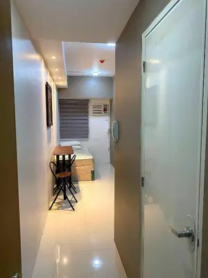 a room with a hallway with a table and a bed at Aral Realty and Property Management in Manila